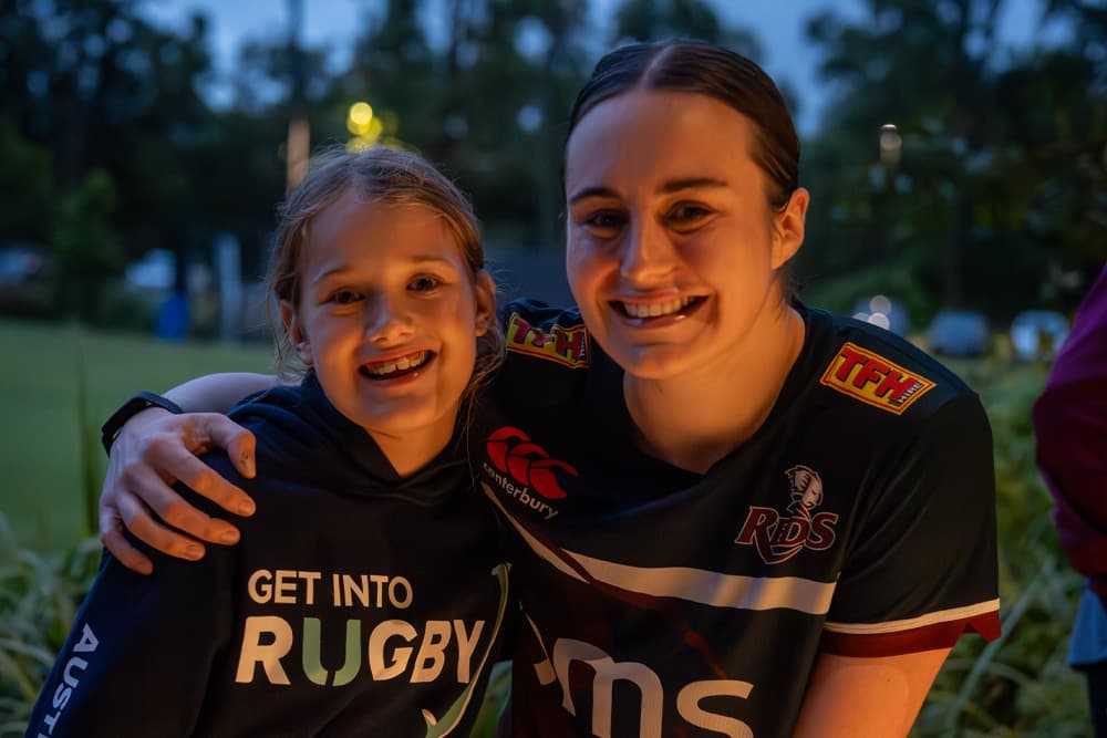 Young rugby fan Harper Cluley meets Wallaroo Tiarna Molloy at Reds Open Training Session at Ballymore.