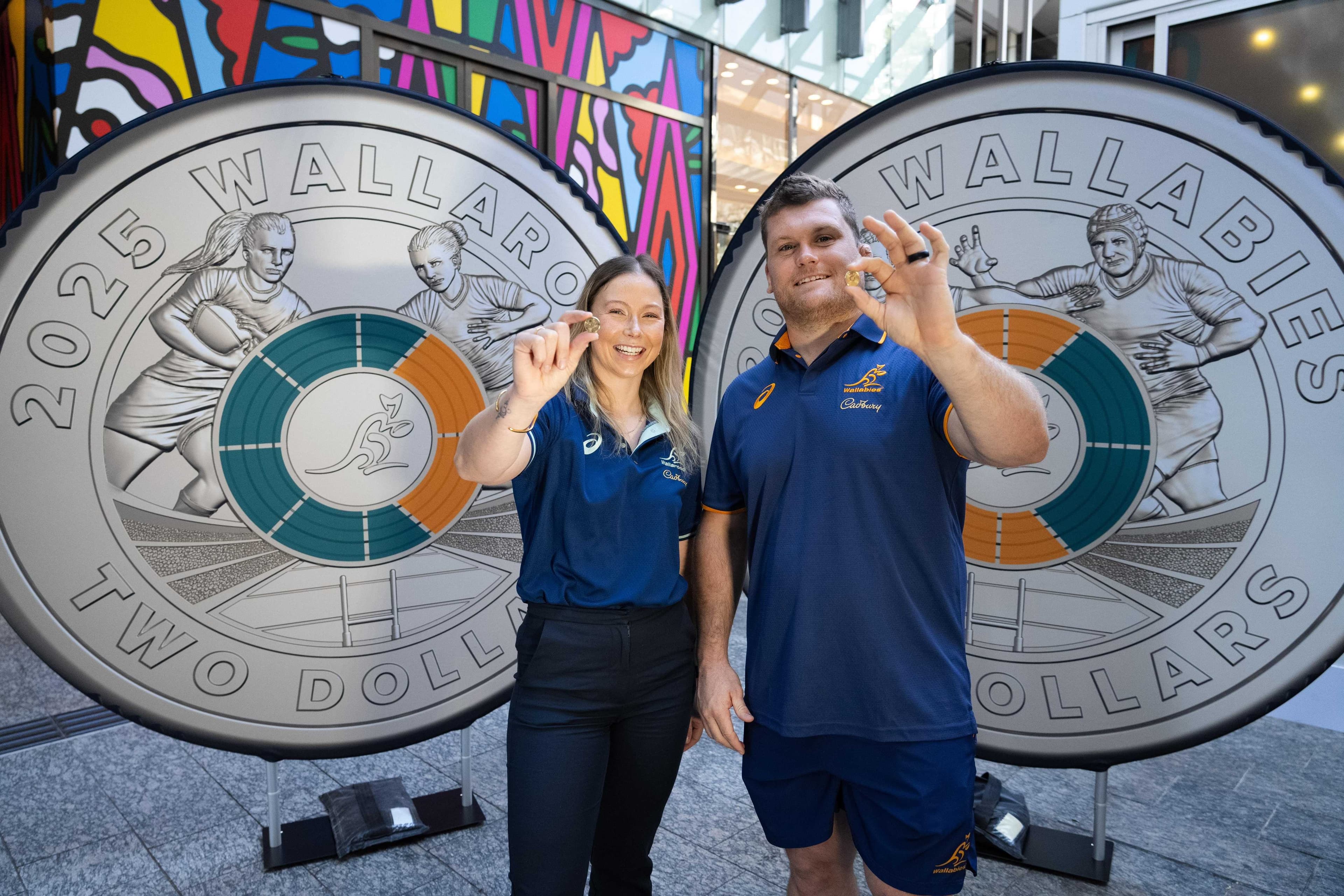 Wallaroos halfback Layne Morgan and Wallabies prop Tom Robertson showcase the newly-minted Australian rugby $2 coins. Picture: Rugby Australia