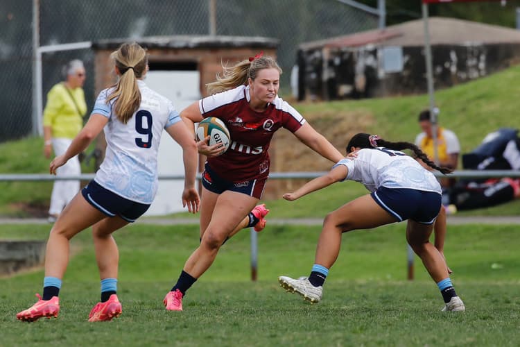 Carys Dallinger fending a NSW Waratahs defender during her Next Gen 7s debut for the Reds